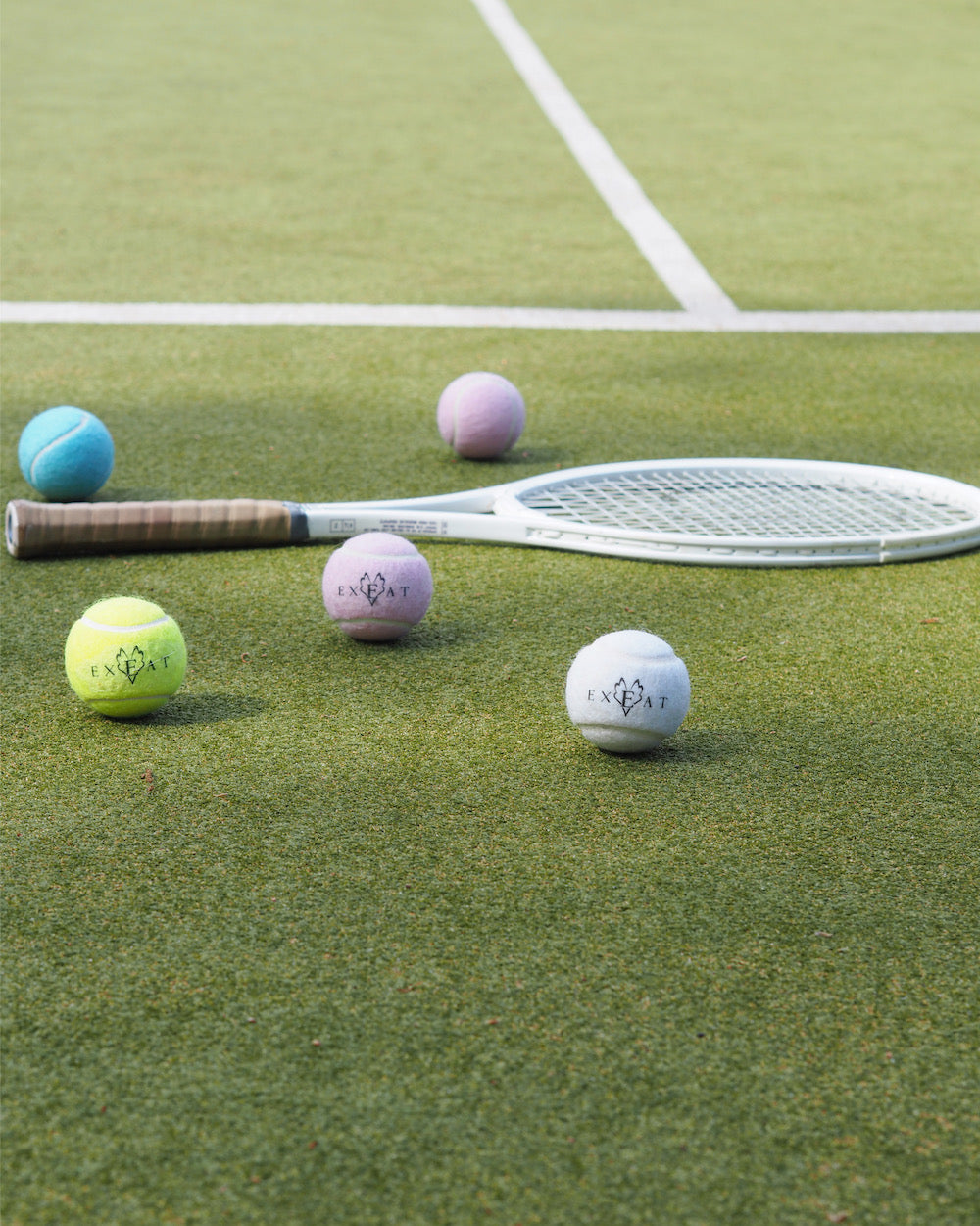 exeat-english-tennis-balls-pink-white-blue-yellow-colourful.jpg